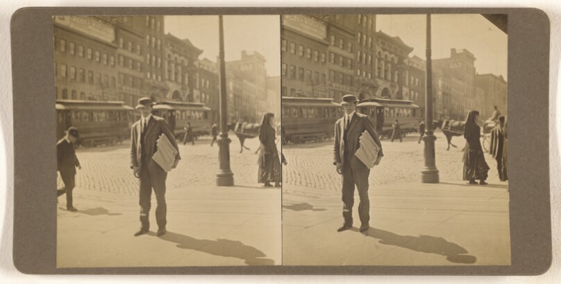 [Man on street with stack of newspapers under his arm, Albany, N.Y.]