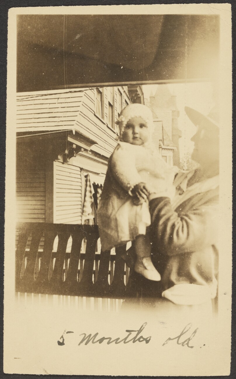 [Woman holding baby]