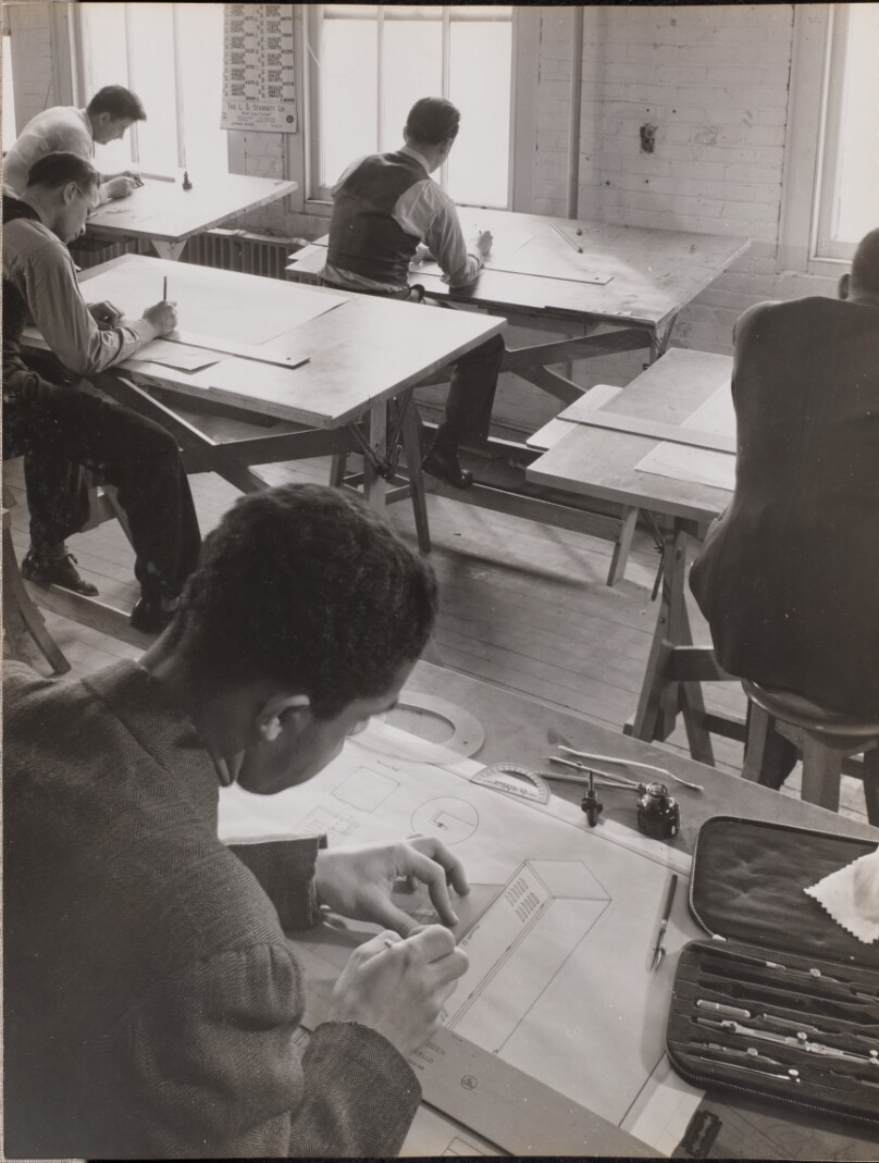 [Four men sketch at drafting tables]