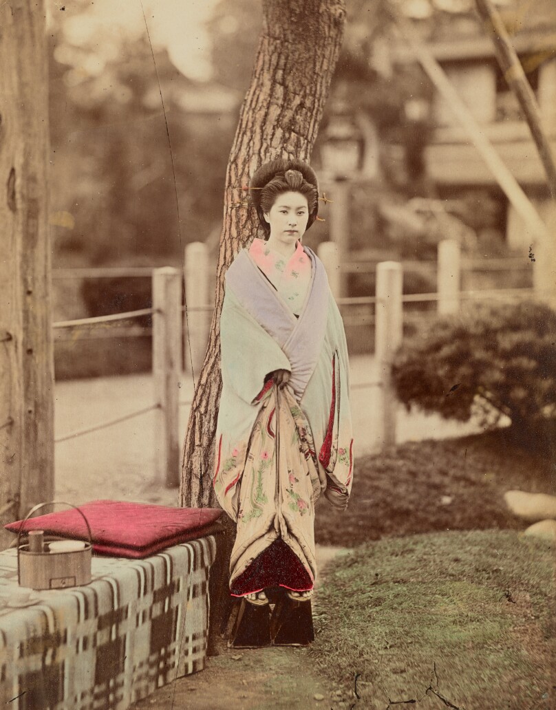 [Girl standing near tree]