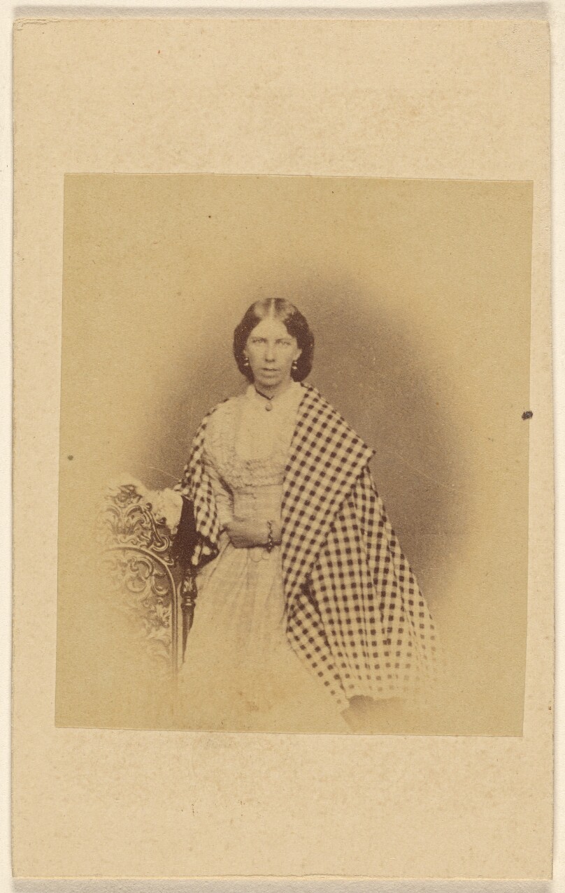 [Unidentified woman with checkered shawl, standing]