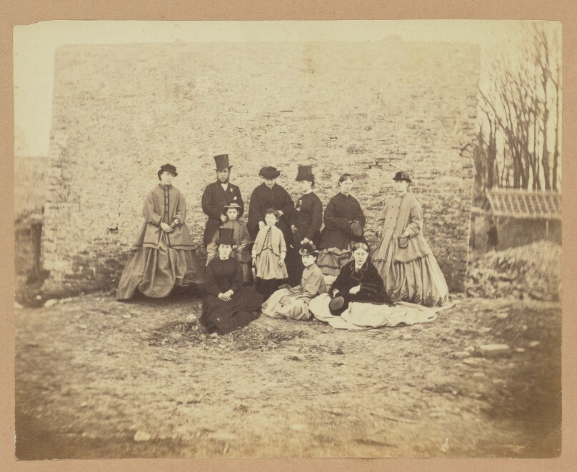 [Group portrait of a man, women, and children]