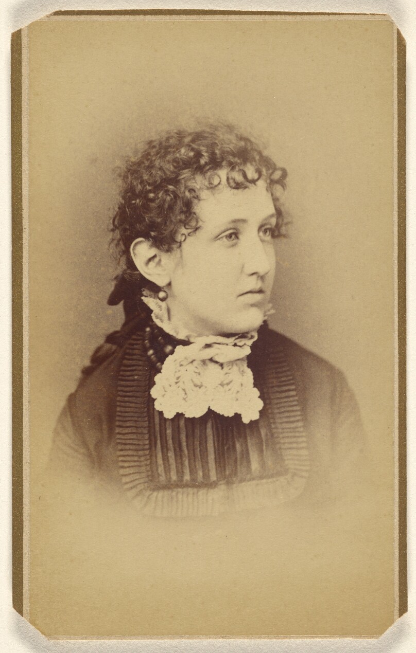 [Unidentified woman with curly hair, printed in vignette-style]