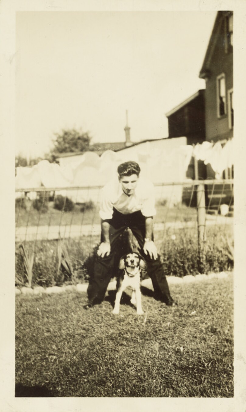 [Man playing with dog]