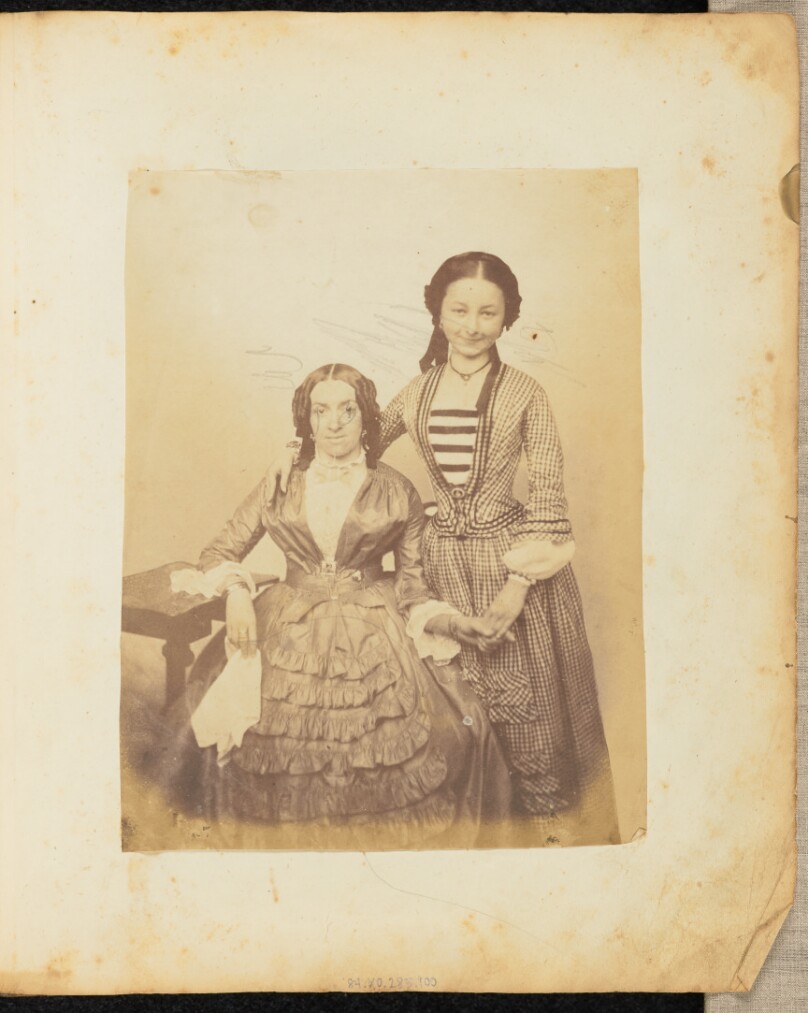 [Portrait of two women holding hands]