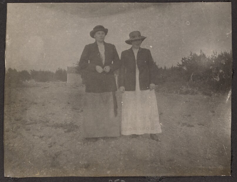 [Two women in dark jackets]