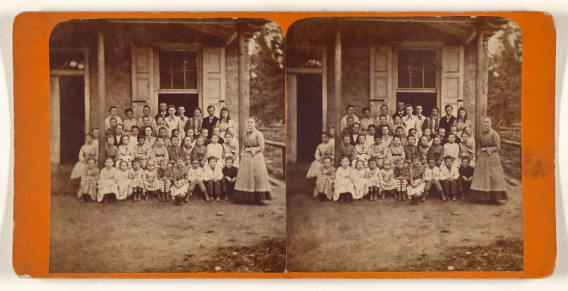 [Group of school children and teacher posed outside]