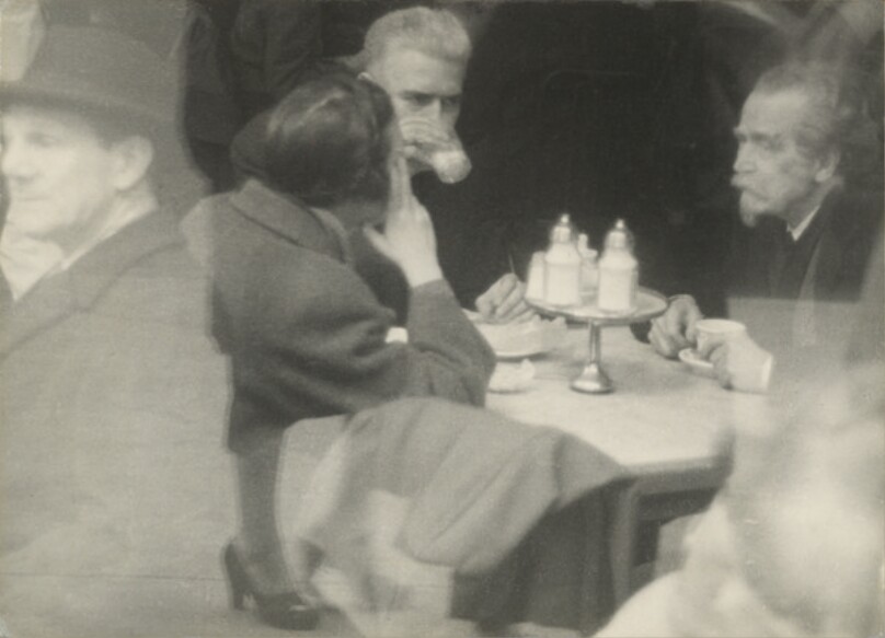 [Two Men and a Woman at a Cafe with Window Reflection]