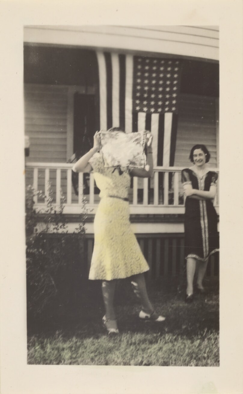 [Woman in front of flag]