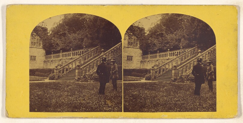 [Two men talking on grounds of large British estate]