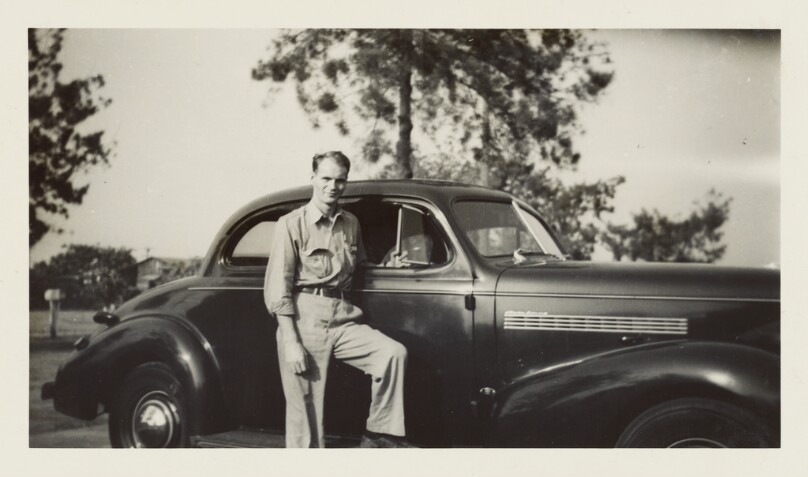 [Man posing with car]