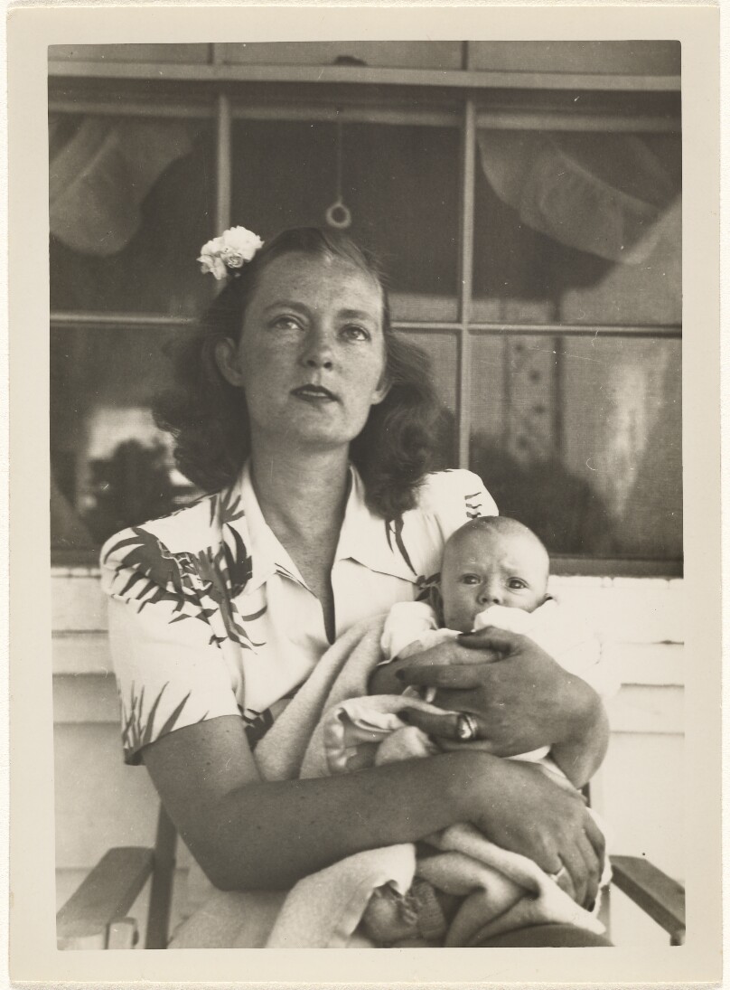 [Woman holding an infant]