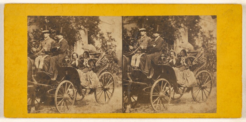 [Two women in a horse-drawn carriage with two men drivers wearing top hats]