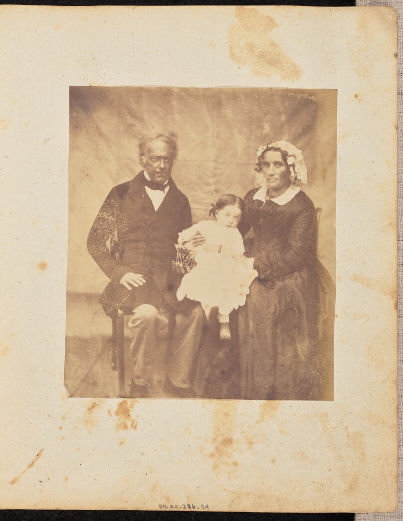 [Portrait of a man and woman with a young child]
