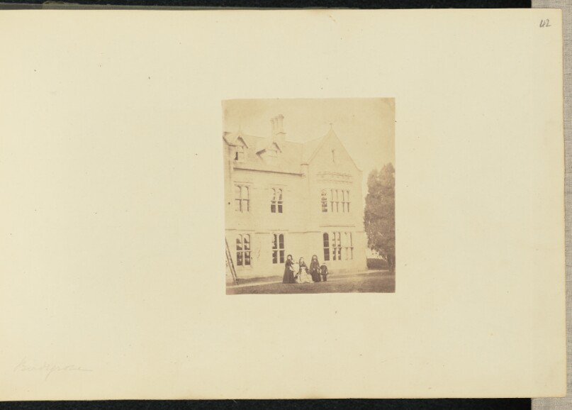 [Group portrait in front of house]