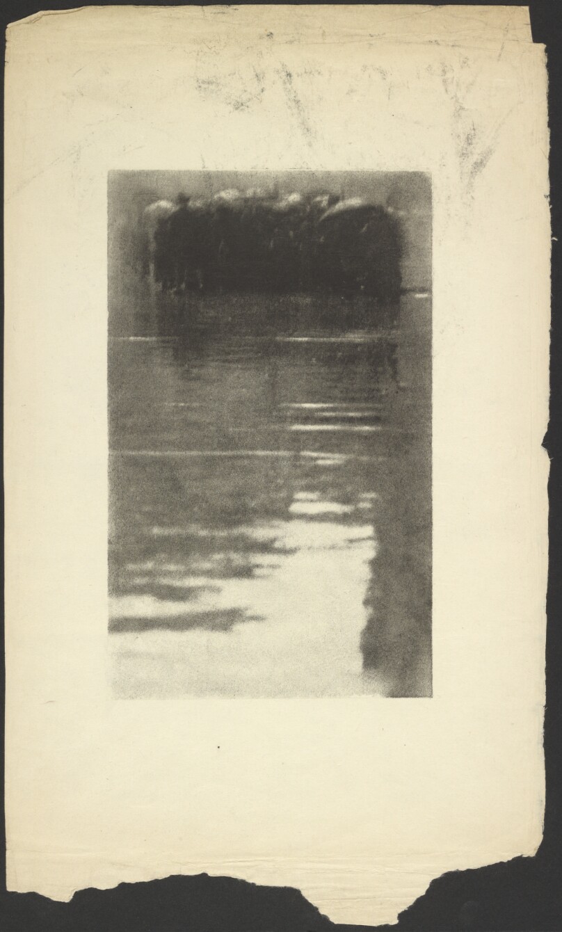 [People gathered on rainy street]