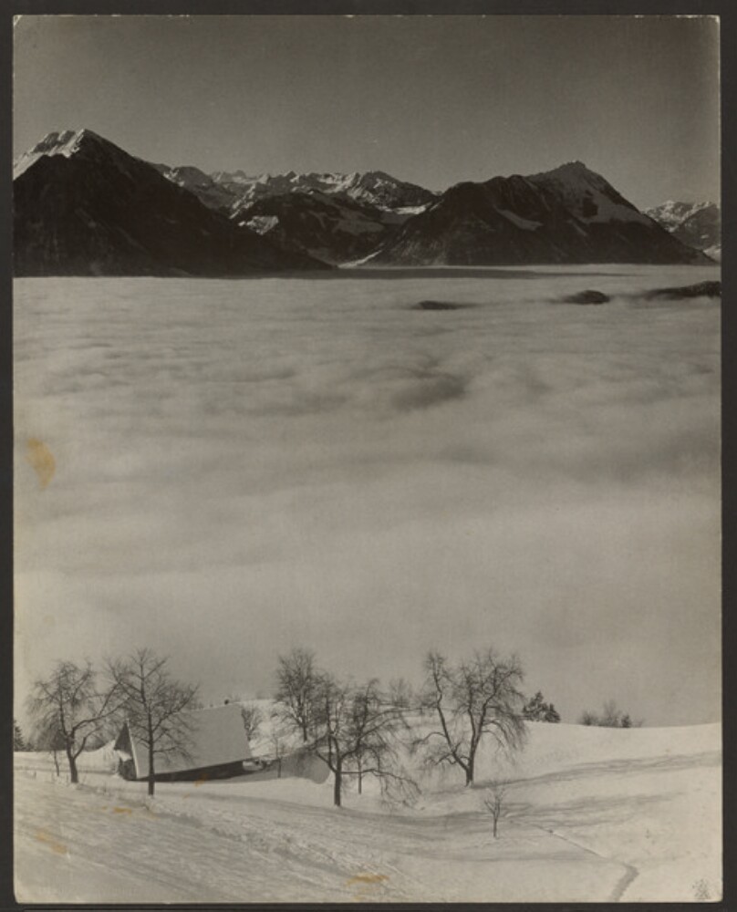 [Cabin on snowy mountainside with clouds]