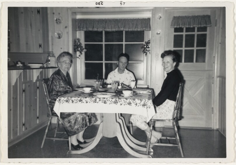 [Three people at kitchen table]
