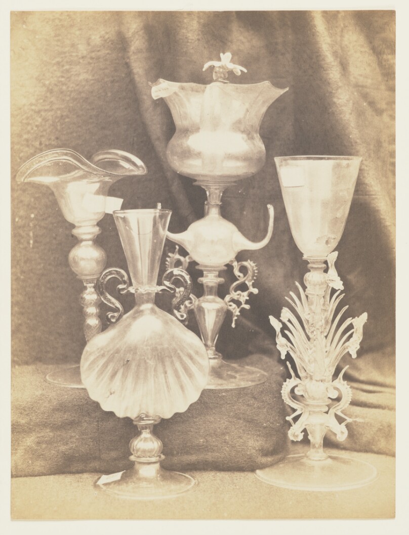 [Four colorless glass objects]