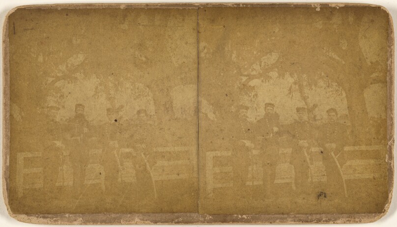 [Group of four Civil War soldier leaning on a white fence]