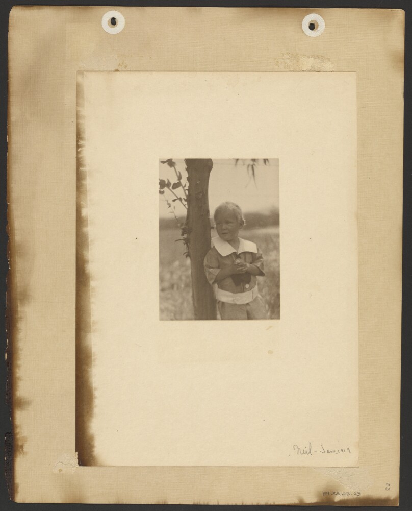[Neil Weston, leaning against a tree, close up]
