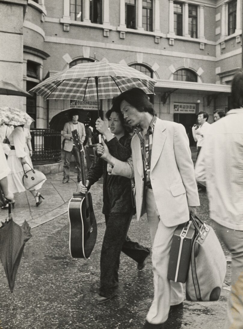 Couple with Suitcases and Guitar