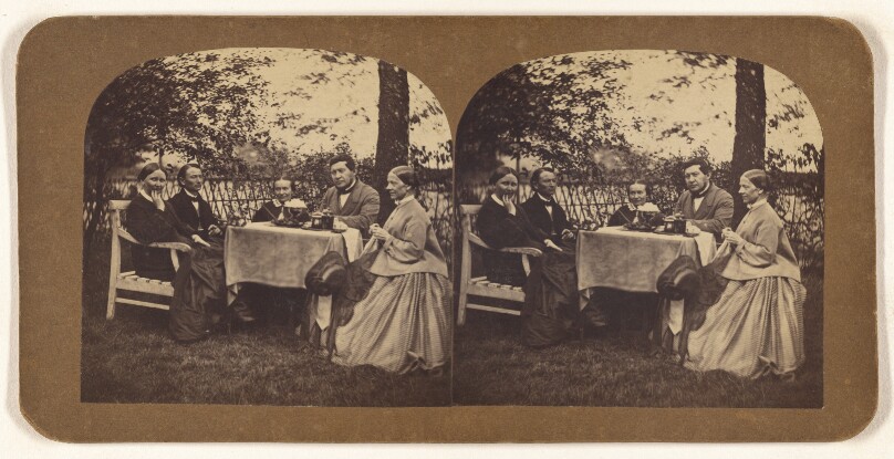 [Group of five people seated at a table: three women and two men]