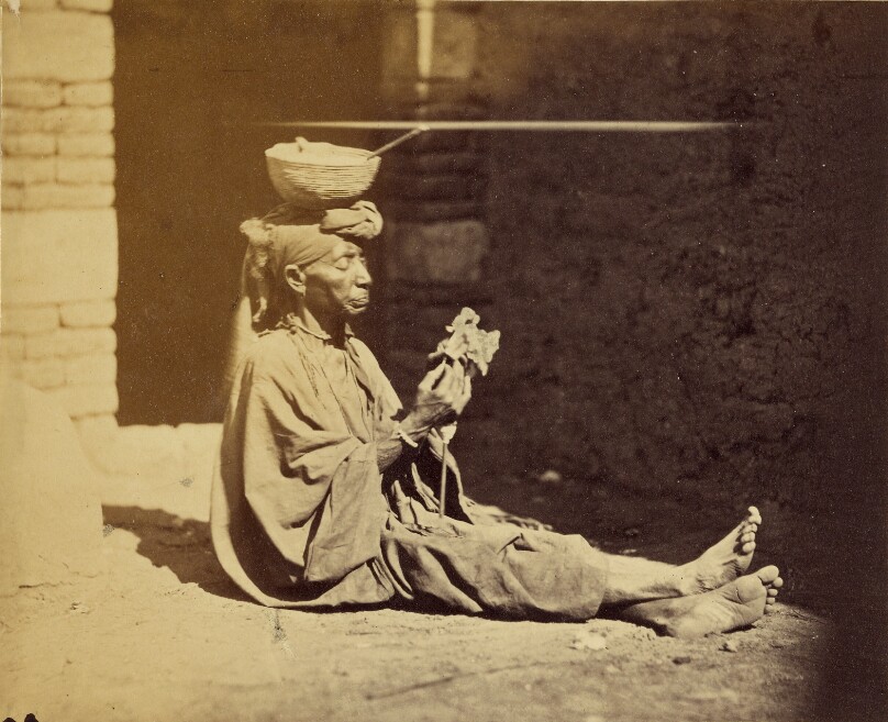 [Portrait of seated beggar, probably near Cairo]