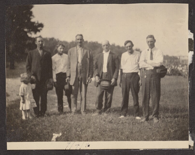 [Group posing with young girl]