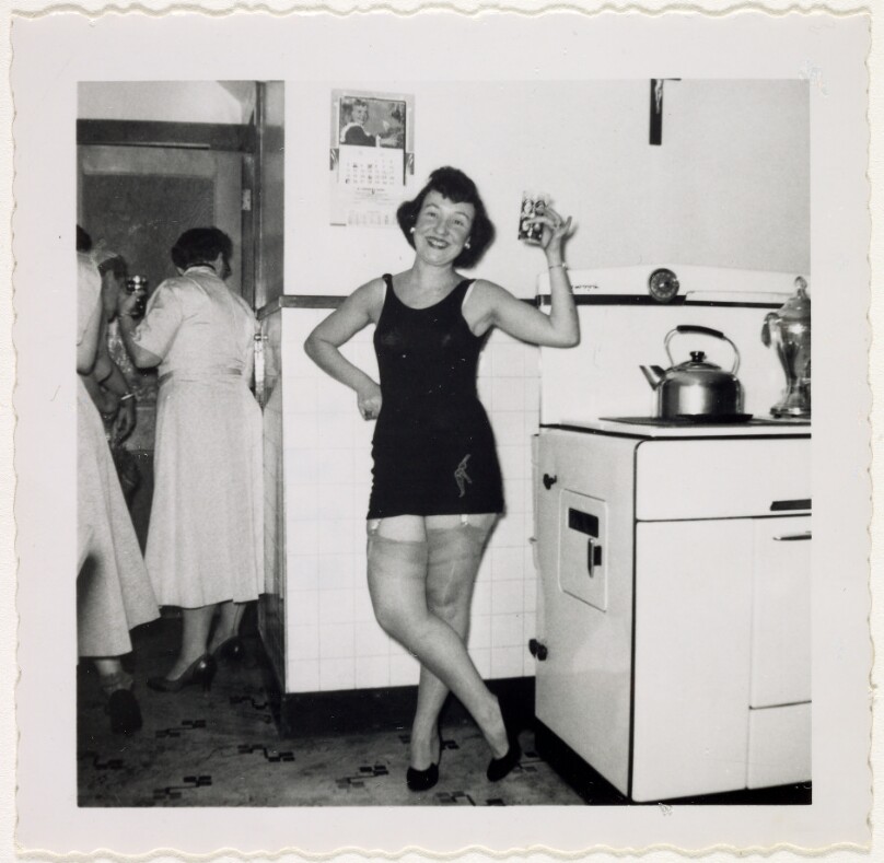 [Woman posing in kitchen]