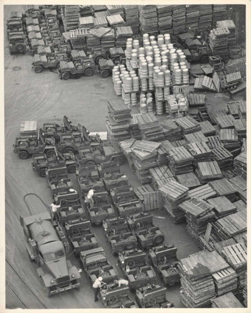 Supplies and jeeps ready for loading onto a cargo vessel in P. H.