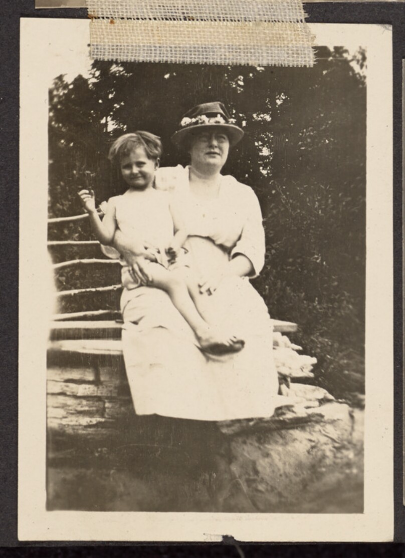 [Woman holding a child]