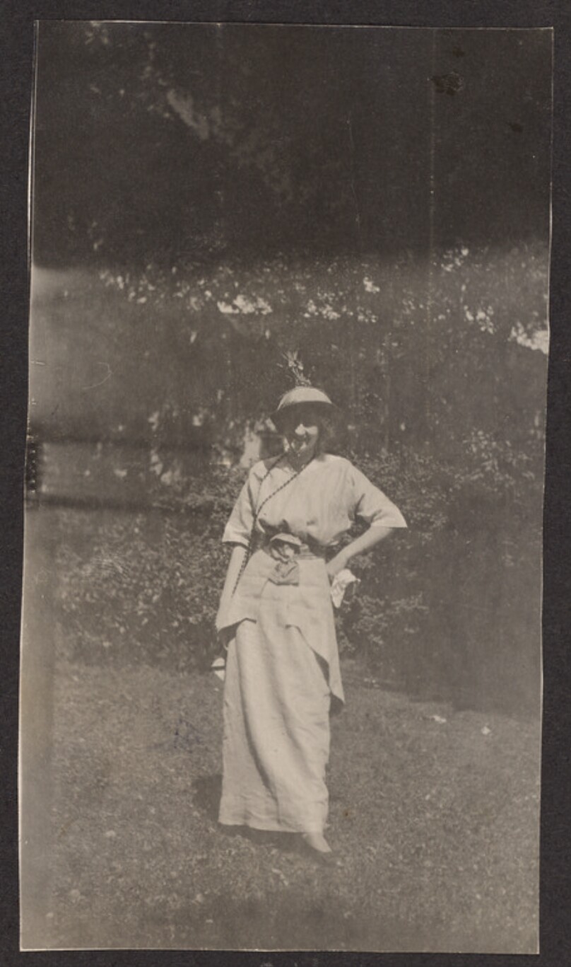 [Woman posing on a lawn]