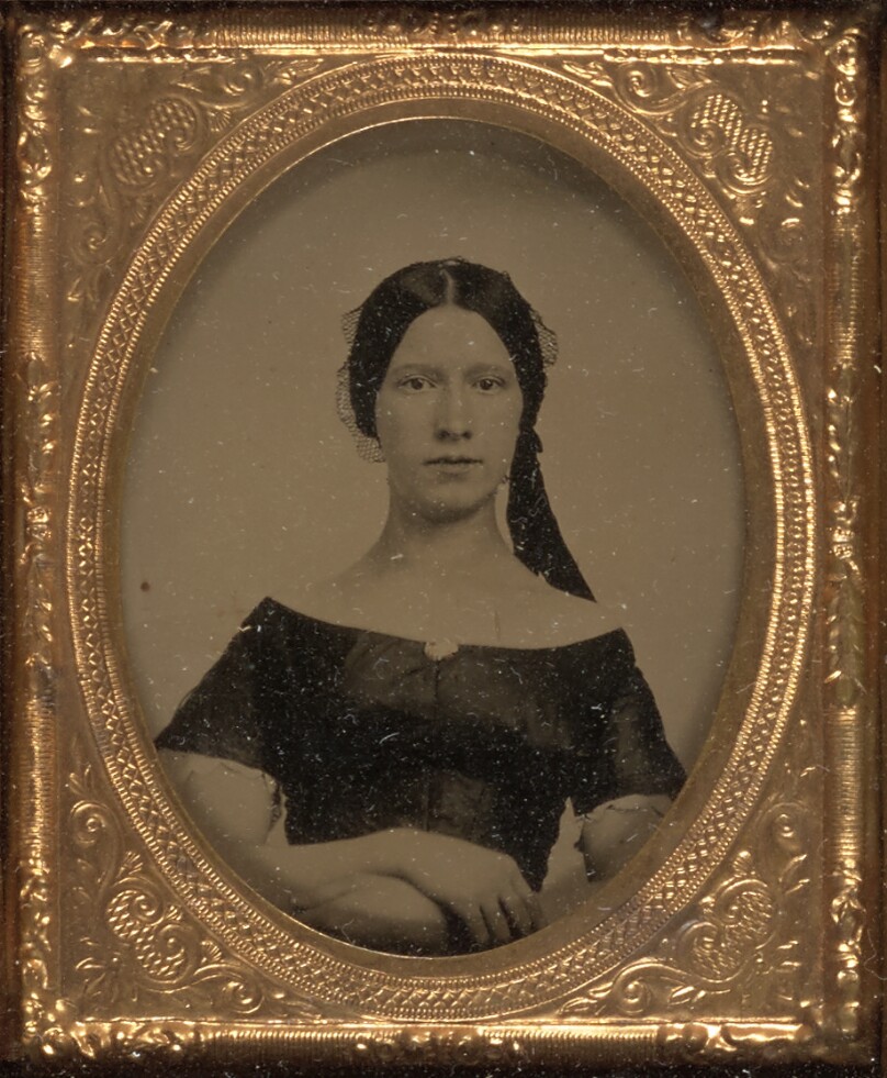 [Young woman seated]