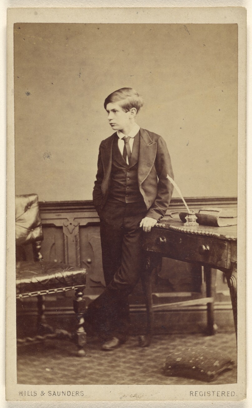 [Unidentified well-dressed young boy, standing]
