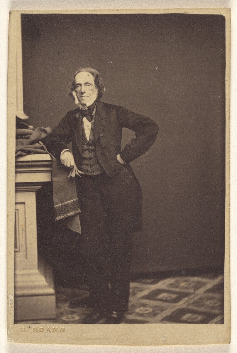 [Unidentified man with white muttonchops, standing]