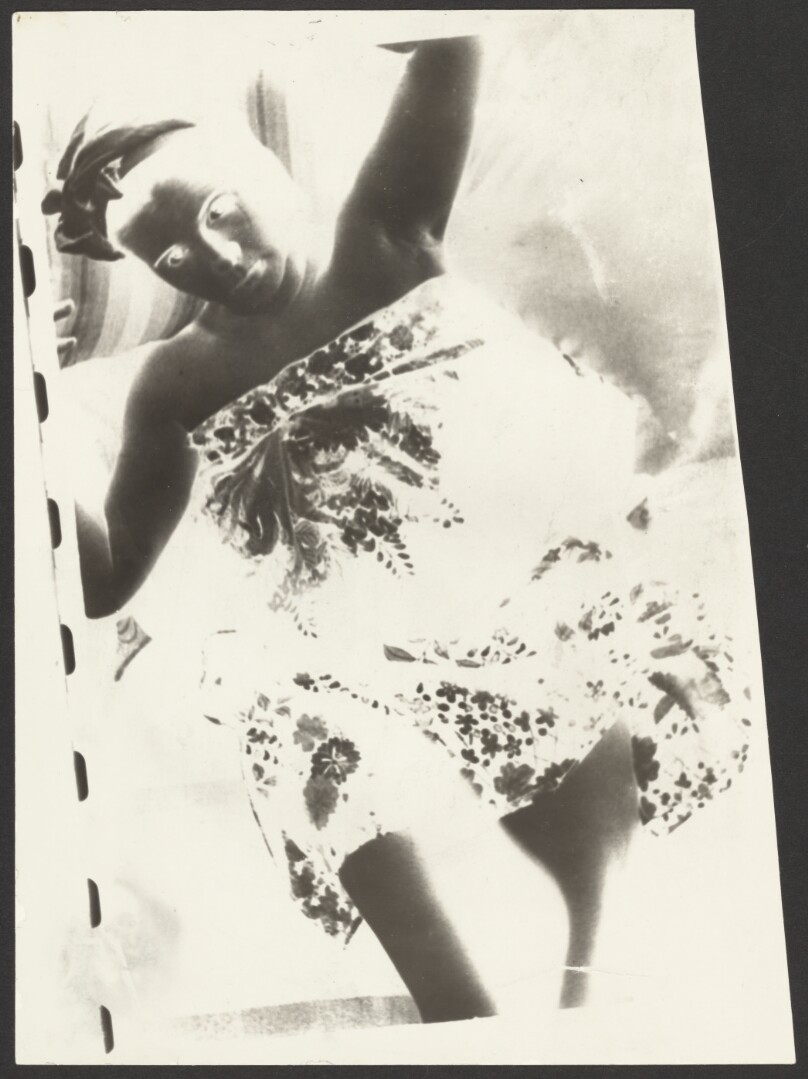 [Negative print of reclining female in flowered dress]