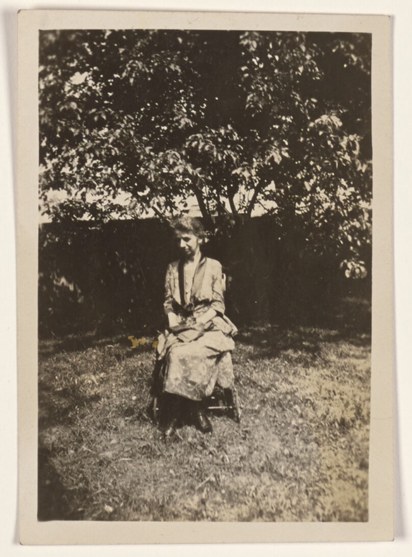 [Woman seated in a chair on a lawn]