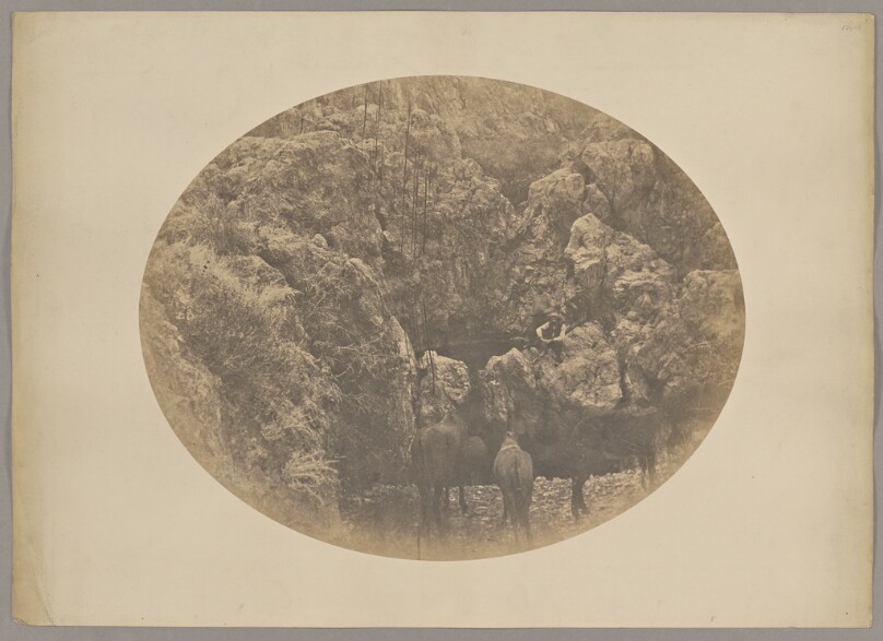 [Men and horses on rocks]