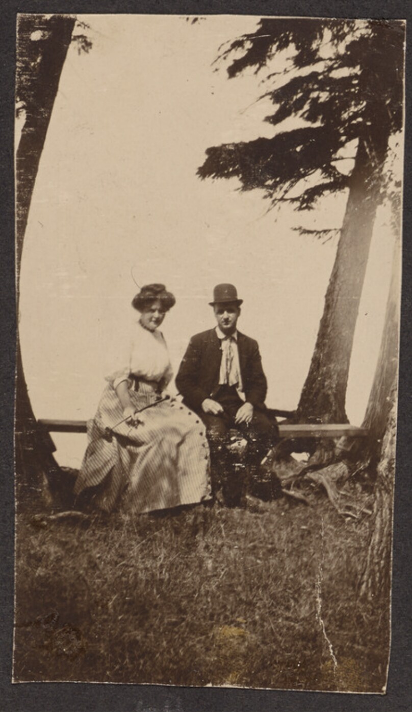 [Man and woman sitting on a bench]
