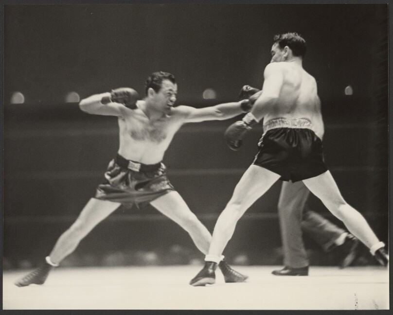 [Two boxers fighting]