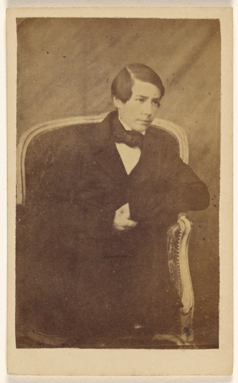 [Unidentified young boy, seated]