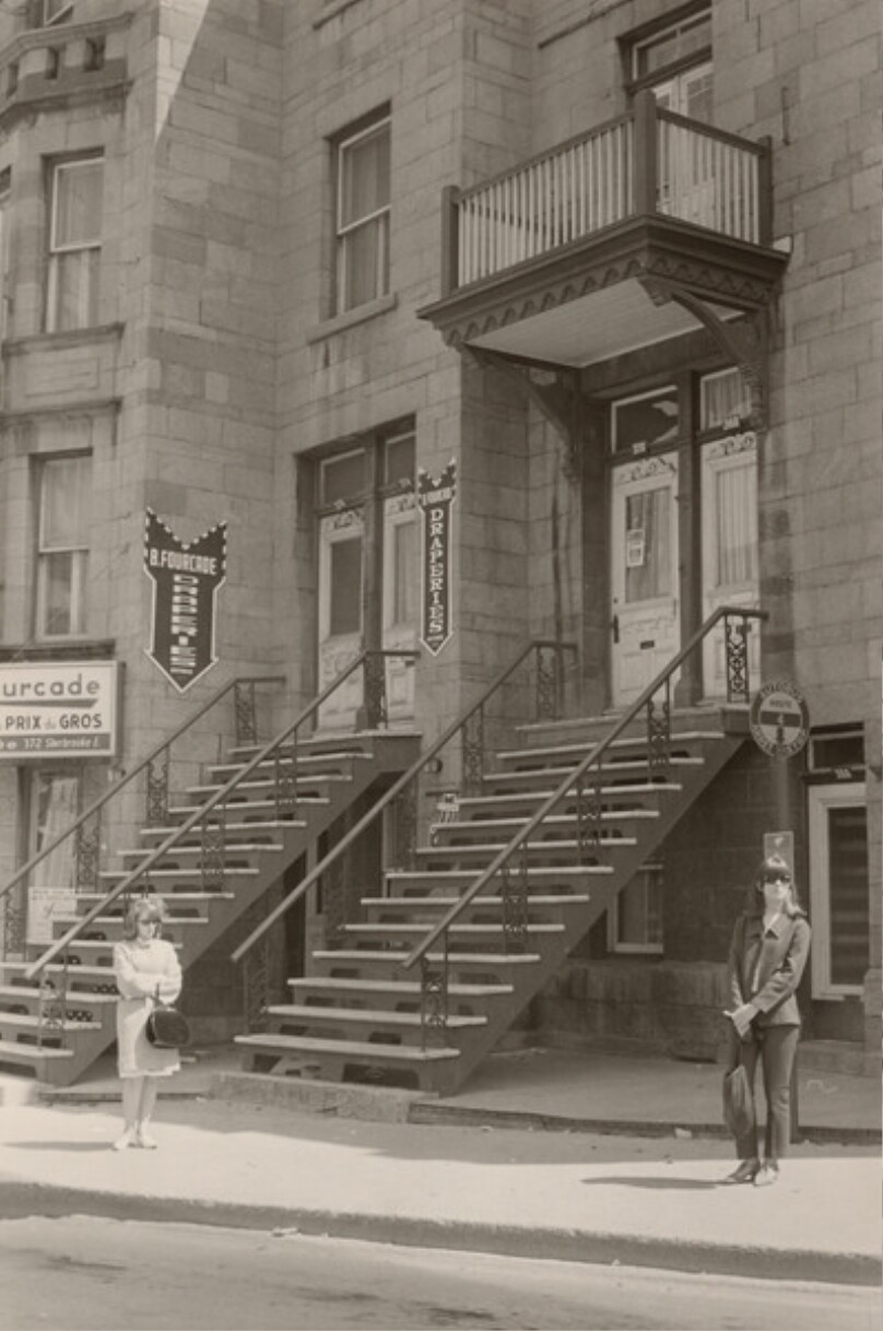 [Bus stop and building facade]