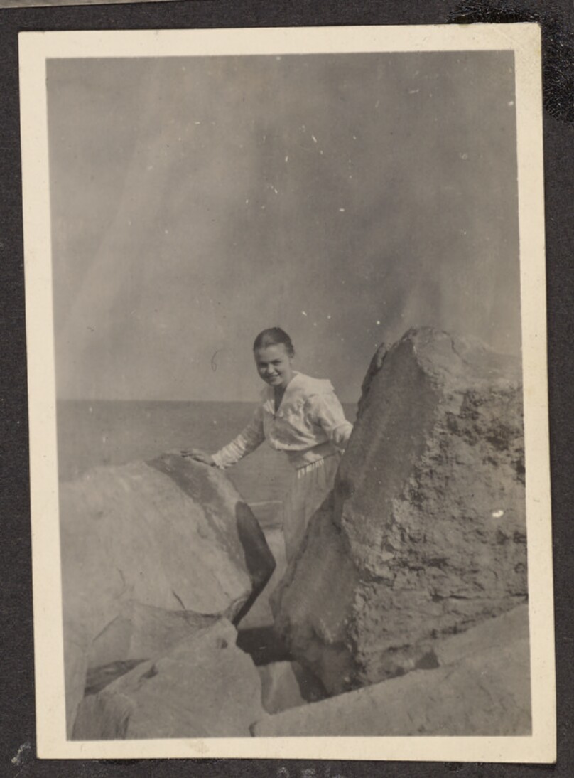 [Woman posing between two large rocks]