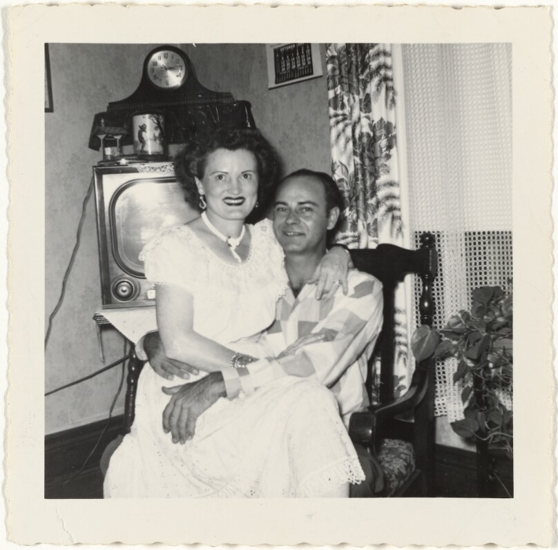 [Seated man and woman with television]