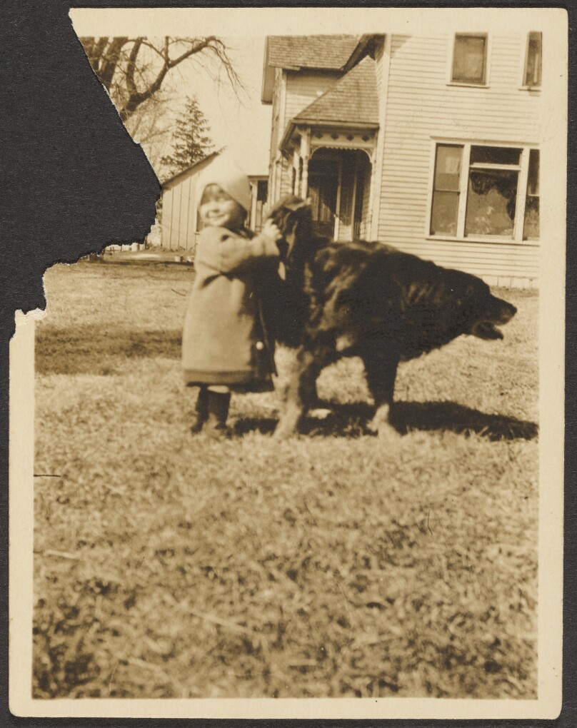 [Child playing with dog]