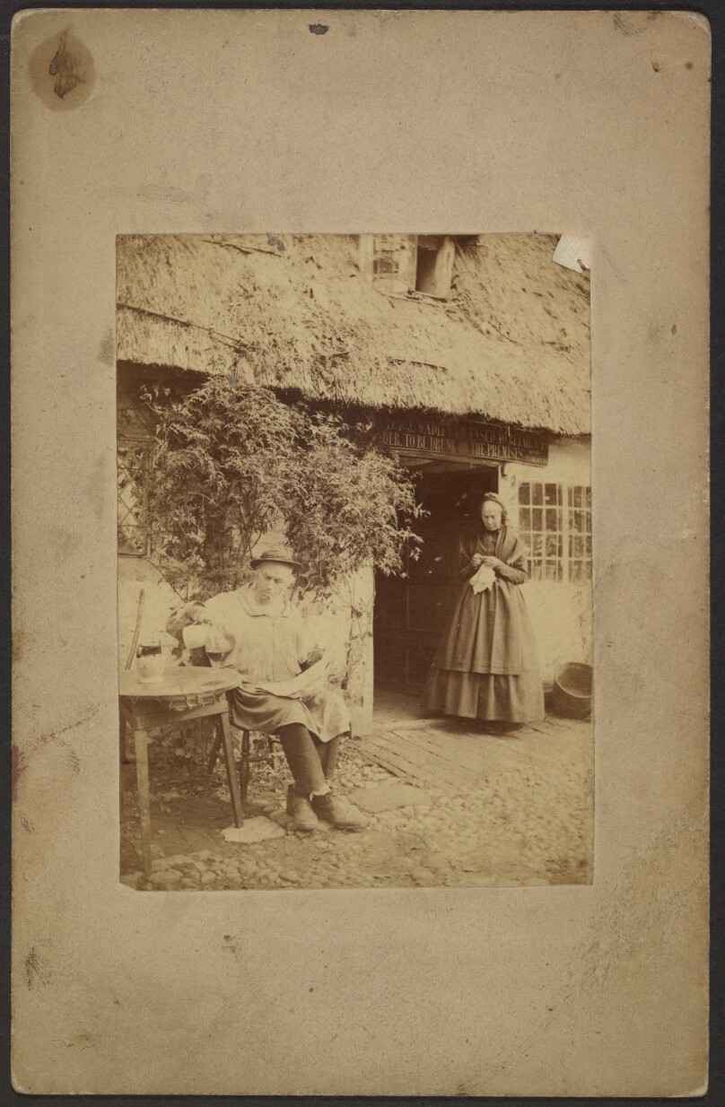 [Man with a drink outside a cider house]