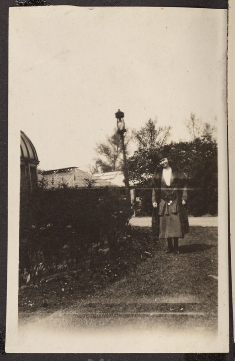 [Woman standing on a lawn]