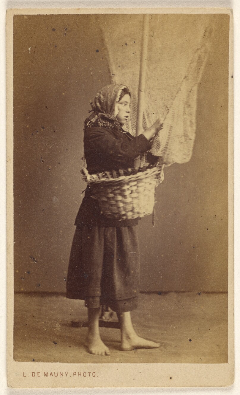 [Peasant woman standing, holding a basket with a long pole and net]