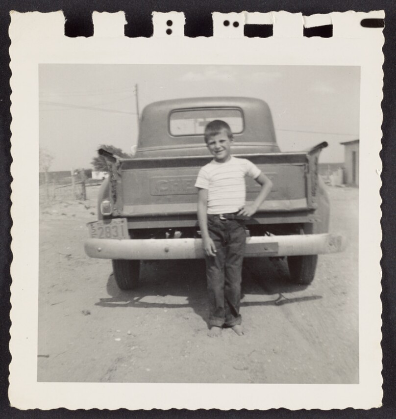 [In front of the back of a pick up truck]